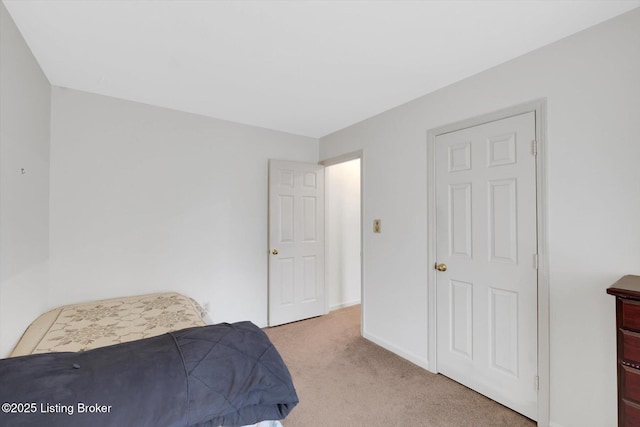 bedroom with carpet flooring and baseboards