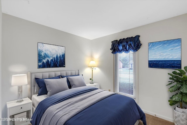 bedroom featuring carpet and baseboards