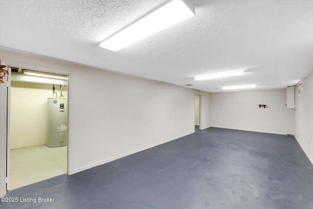 finished basement featuring water heater, a textured ceiling, and baseboards