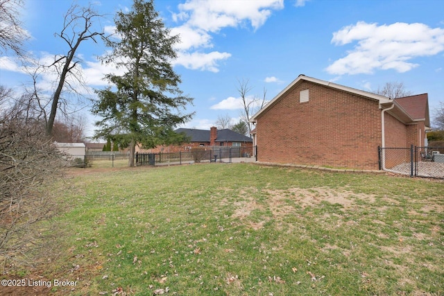 view of yard featuring a fenced backyard and a gate