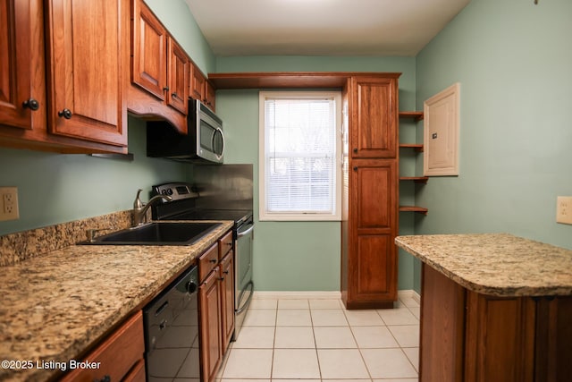 kitchen featuring light stone counters, stainless steel appliances, light tile patterned floors, and sink