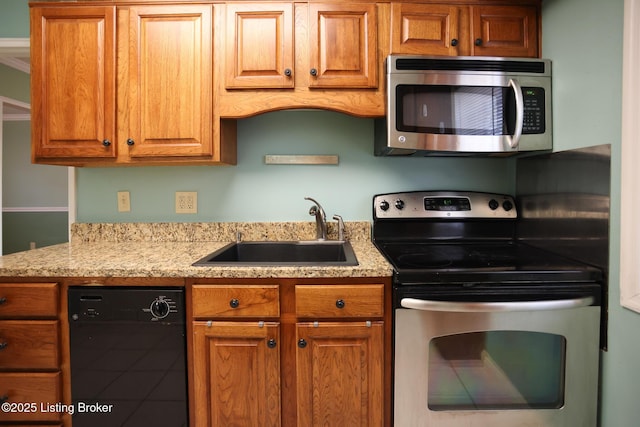 kitchen featuring stainless steel appliances, light stone countertops, and sink