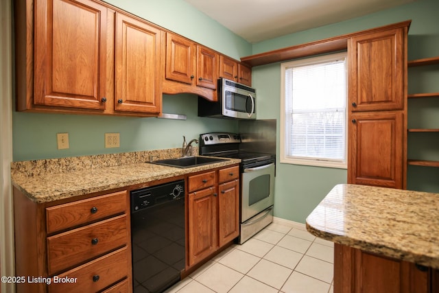 kitchen with light stone countertops, appliances with stainless steel finishes, light tile patterned floors, and sink