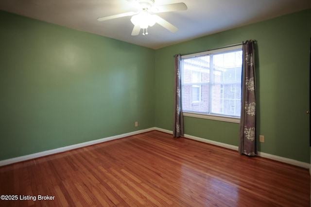 spare room featuring wood-type flooring and ceiling fan