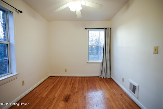 empty room featuring ceiling fan and light hardwood / wood-style floors