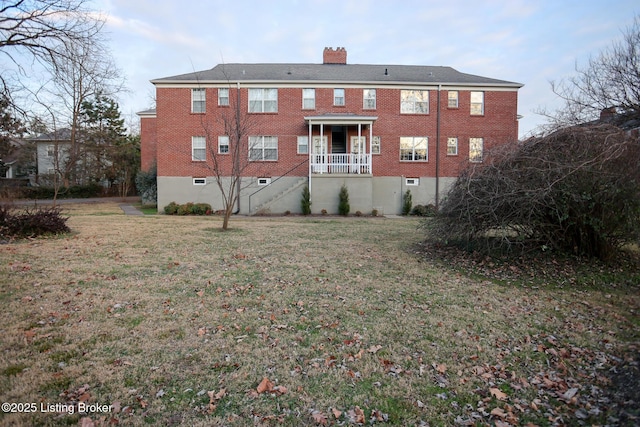 rear view of house with a yard