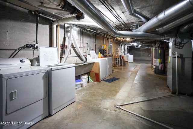 basement featuring independent washer and dryer, heating unit, and gas water heater