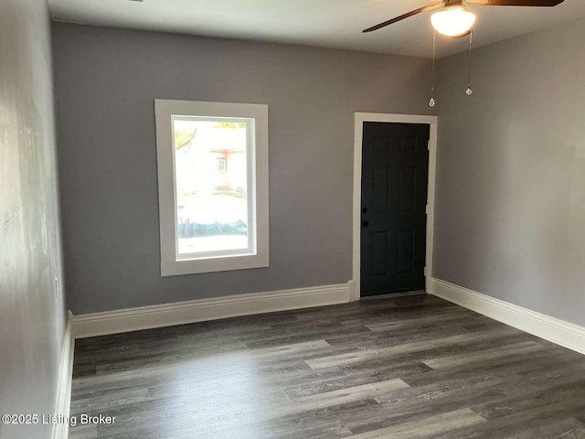 unfurnished room featuring dark hardwood / wood-style flooring and ceiling fan