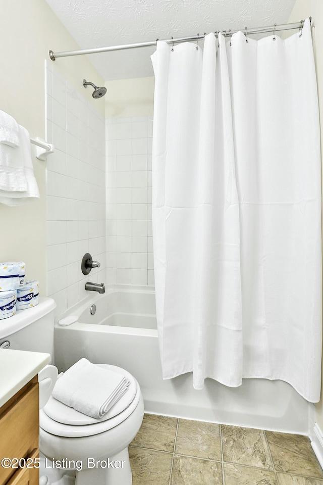 full bathroom featuring vanity, toilet, a textured ceiling, and shower / tub combo