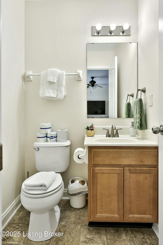 bathroom featuring vanity, ceiling fan, and toilet