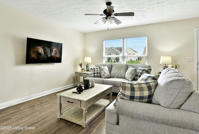 living room with a textured ceiling, dark hardwood / wood-style floors, and ceiling fan