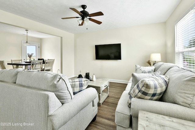 living room with dark hardwood / wood-style floors and ceiling fan