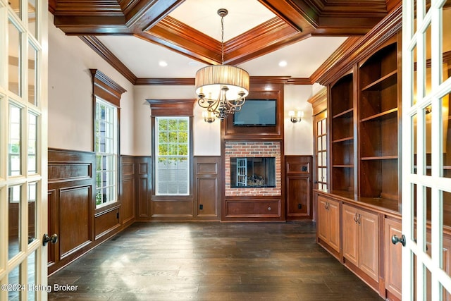 unfurnished office featuring french doors, coffered ceiling, ornamental molding, and a notable chandelier