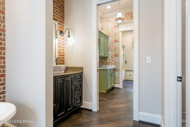 bathroom featuring hardwood / wood-style floors, vanity, and ornamental molding