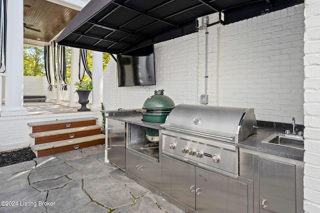 view of patio with area for grilling, a grill, and sink