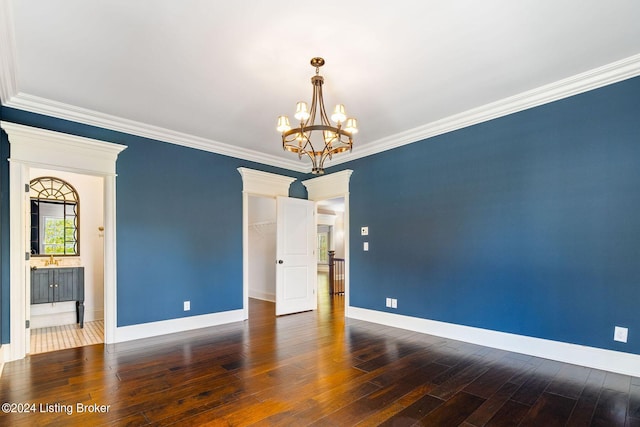 unfurnished room featuring crown molding, dark hardwood / wood-style flooring, and a notable chandelier