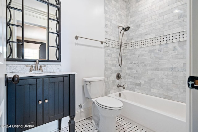 full bathroom featuring vanity, tiled shower / bath, and toilet