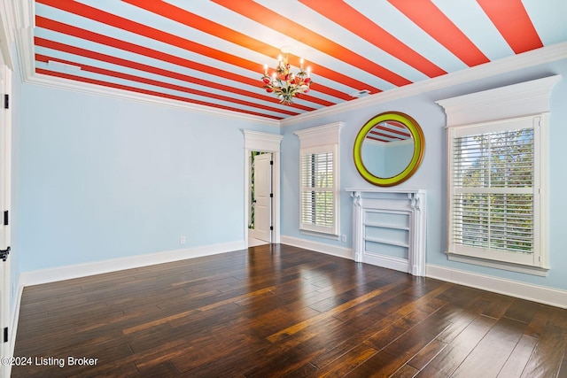 unfurnished living room featuring ornamental molding, dark hardwood / wood-style floors, and a notable chandelier