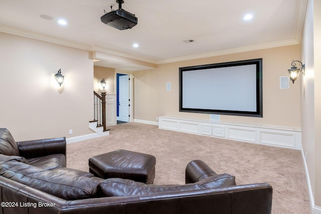 carpeted home theater room featuring crown molding