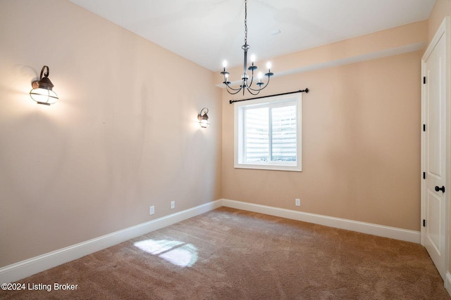 unfurnished room featuring carpet floors and a notable chandelier