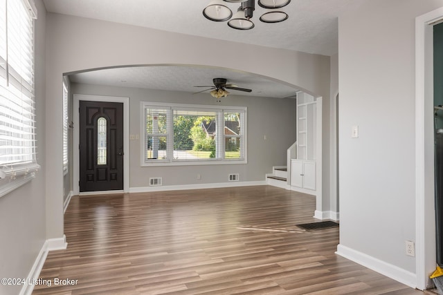 foyer with ceiling fan, hardwood / wood-style floors, and a textured ceiling