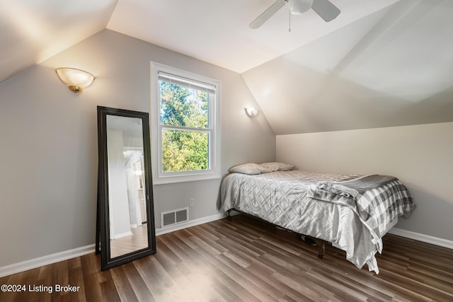 bedroom with dark hardwood / wood-style flooring, ceiling fan, and lofted ceiling