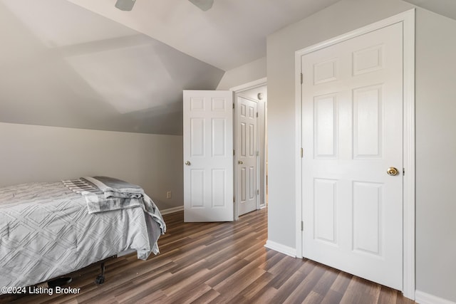 bedroom with dark hardwood / wood-style flooring, ceiling fan, and lofted ceiling