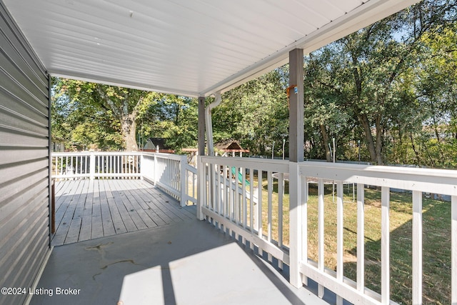 wooden terrace featuring a yard