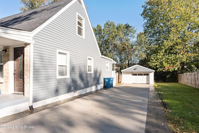 view of home's exterior featuring an outbuilding, a garage, and a lawn