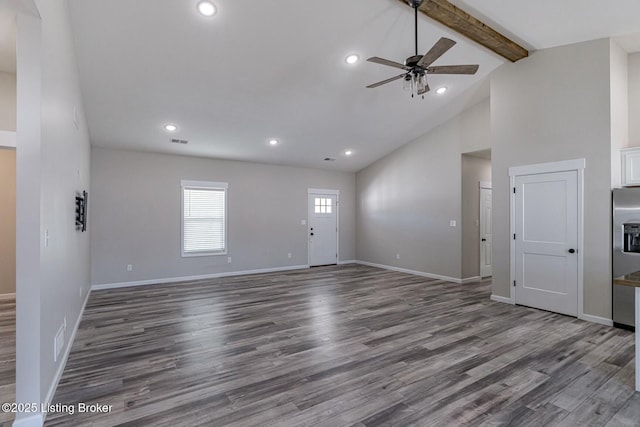 unfurnished living room with beam ceiling, ceiling fan, high vaulted ceiling, and wood-type flooring