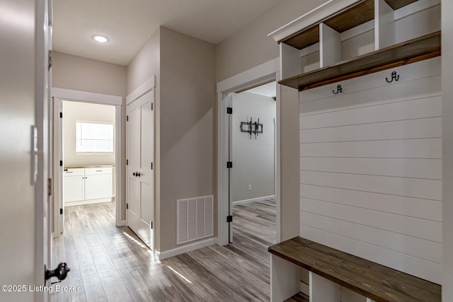 mudroom with light hardwood / wood-style floors