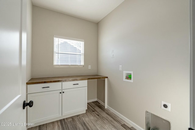 laundry room with washer hookup, cabinets, hookup for an electric dryer, and light wood-type flooring