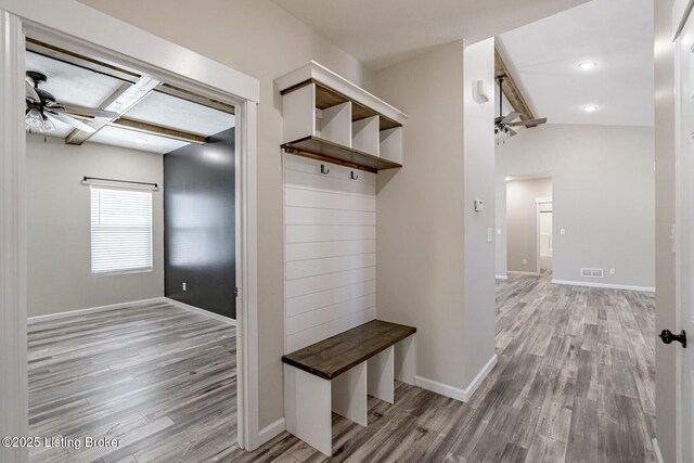 mudroom with coffered ceiling, ceiling fan, light hardwood / wood-style floors, and beam ceiling