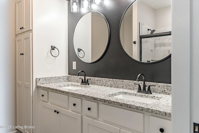 bathroom with a shower with door and vanity