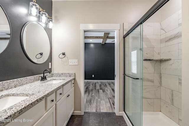 bathroom featuring coffered ceiling, hardwood / wood-style floors, vanity, a shower with shower door, and beam ceiling