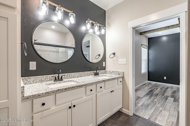 bathroom featuring an enclosed shower, vanity, and hardwood / wood-style flooring