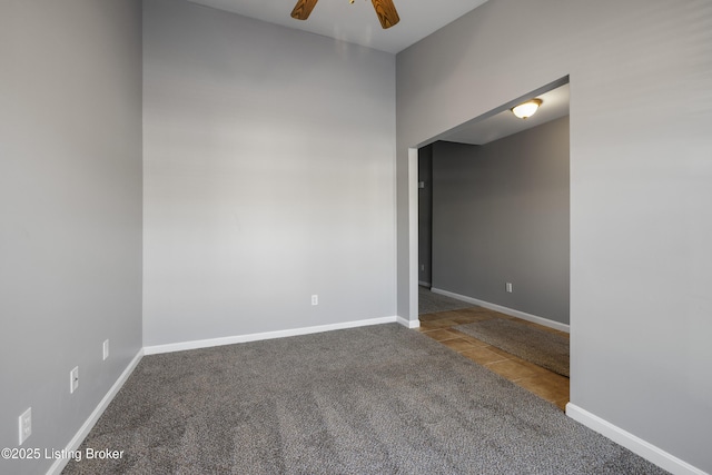 carpeted spare room with ceiling fan