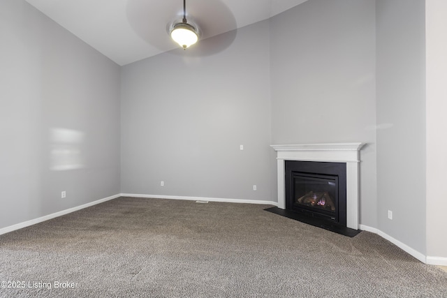 unfurnished living room featuring ceiling fan, lofted ceiling, and carpet