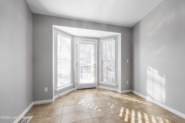 spare room featuring light tile patterned flooring