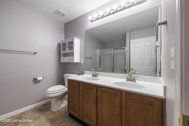 bathroom with vanity, toilet, and a shower with shower door