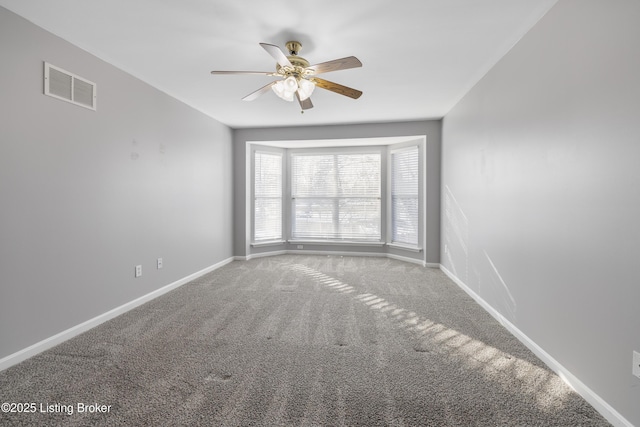 spare room featuring ceiling fan and carpet floors