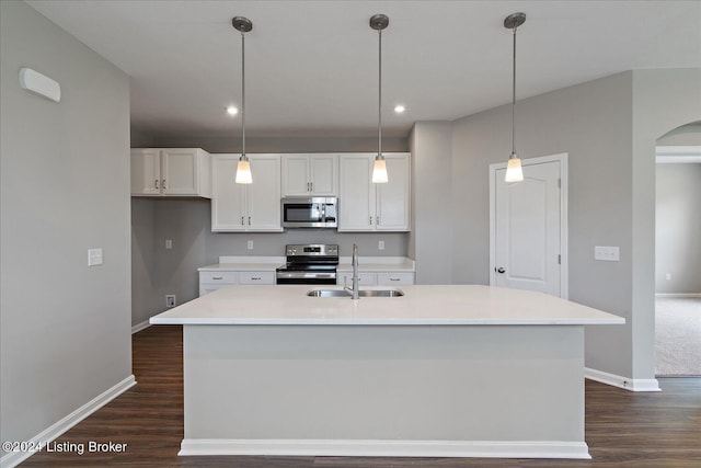 kitchen with a center island with sink, white cabinets, and stainless steel appliances