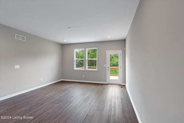 spare room featuring dark hardwood / wood-style flooring