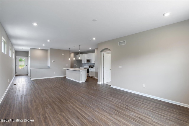 unfurnished living room with dark hardwood / wood-style flooring