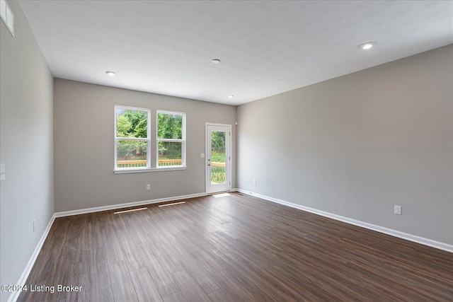 spare room featuring dark wood-type flooring