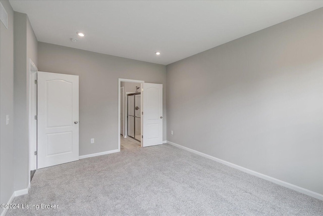 unfurnished bedroom featuring light carpet