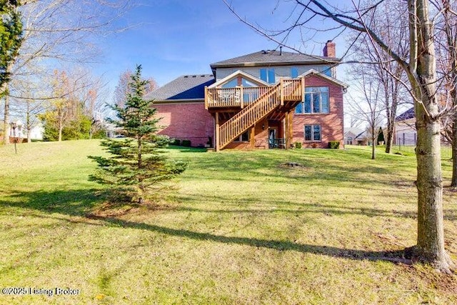 back of property featuring a deck and a yard