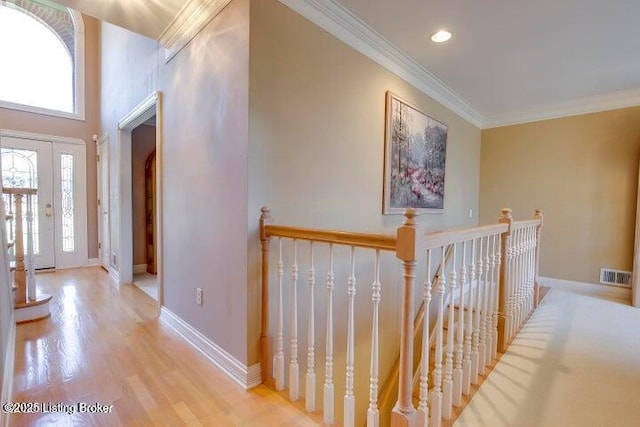 corridor featuring light hardwood / wood-style flooring and ornamental molding