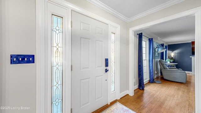 entryway with light hardwood / wood-style floors and ornamental molding