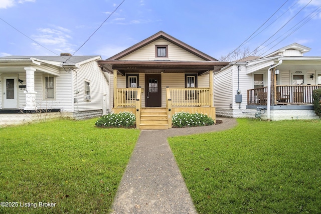 bungalow with covered porch and a front yard